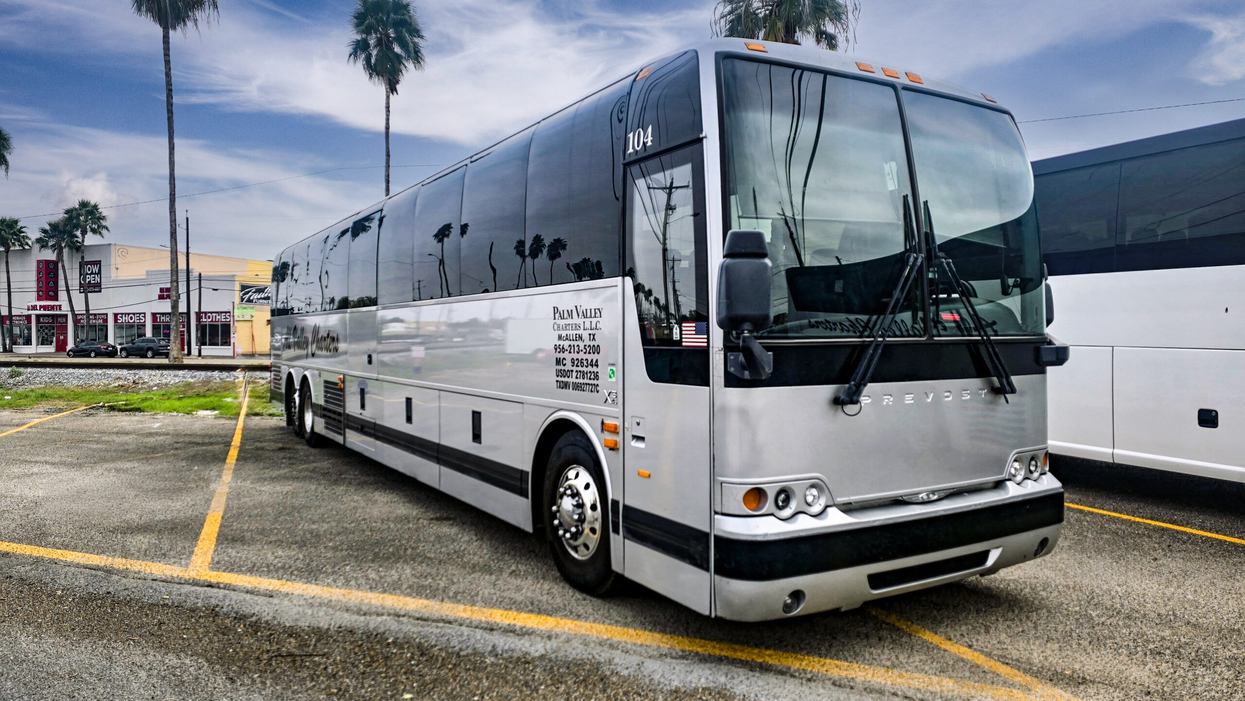 Group of passengers boarding a Palm Valley charter bus